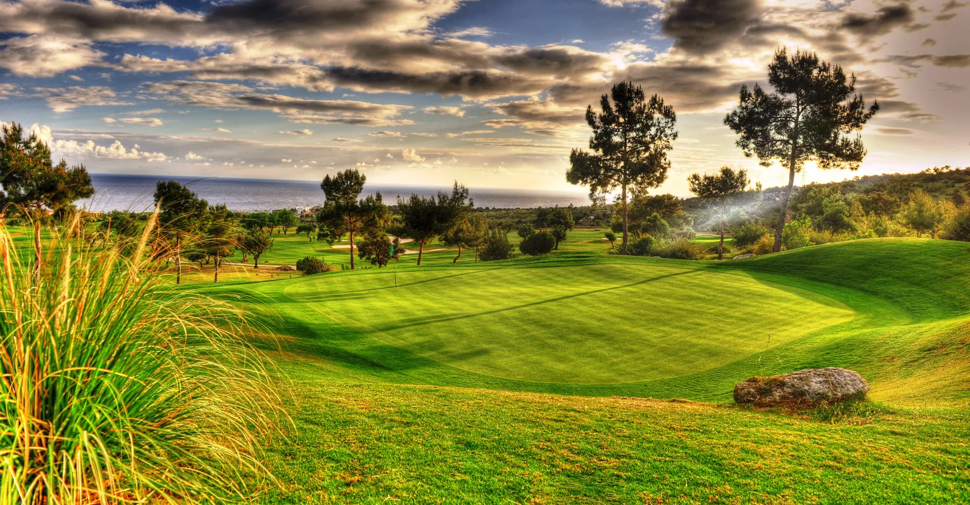 Private luxury taxi arriving at Korineum Golf & Beach Resort, Esentepe, North Cyprus showcasing golf course and Mediterranean Sea