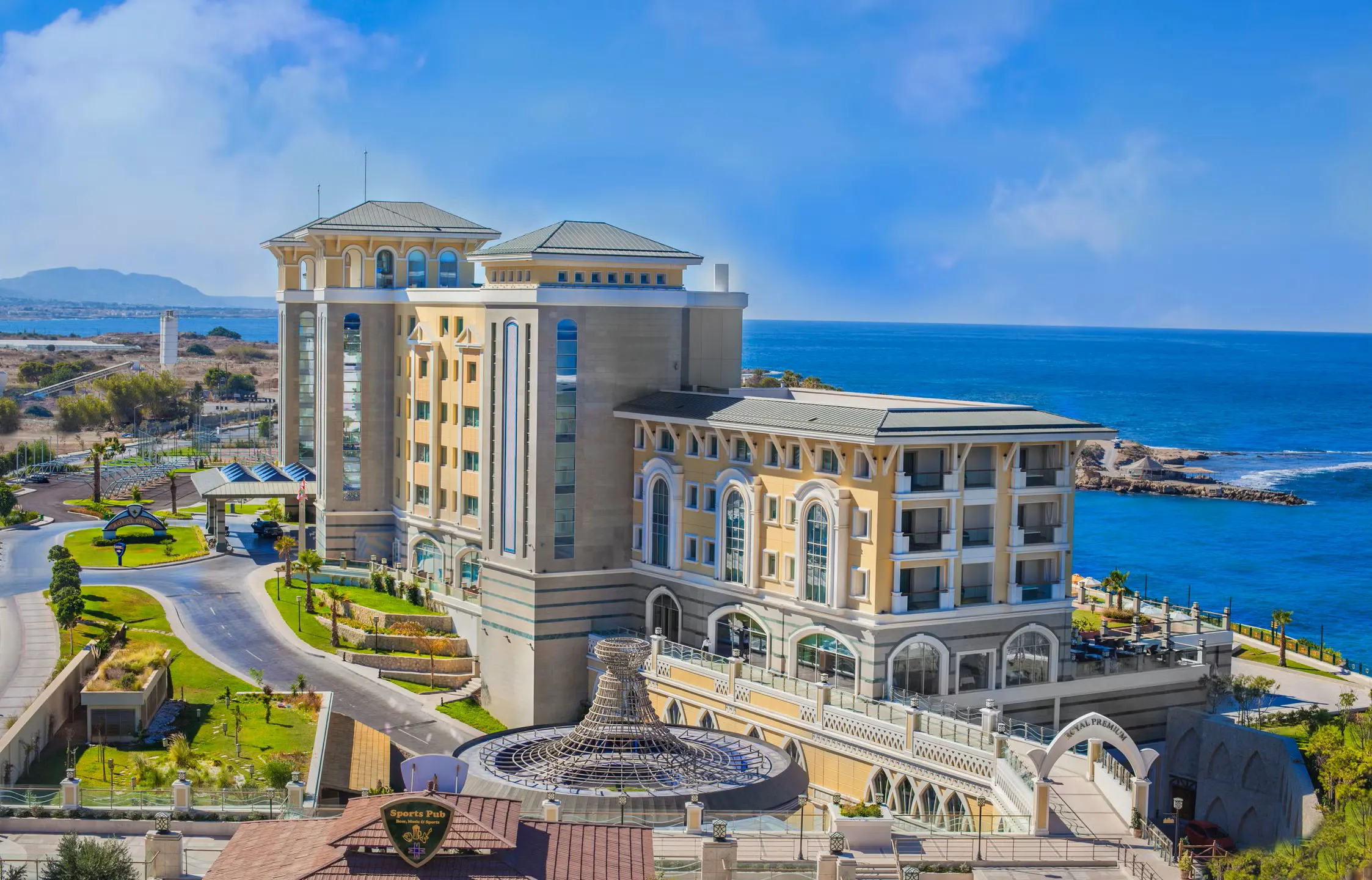 Luxury private taxi arriving at Merit Royal Premium Hotel & Spa, 5-star resort in Kyrenia with expansive pools and sea views