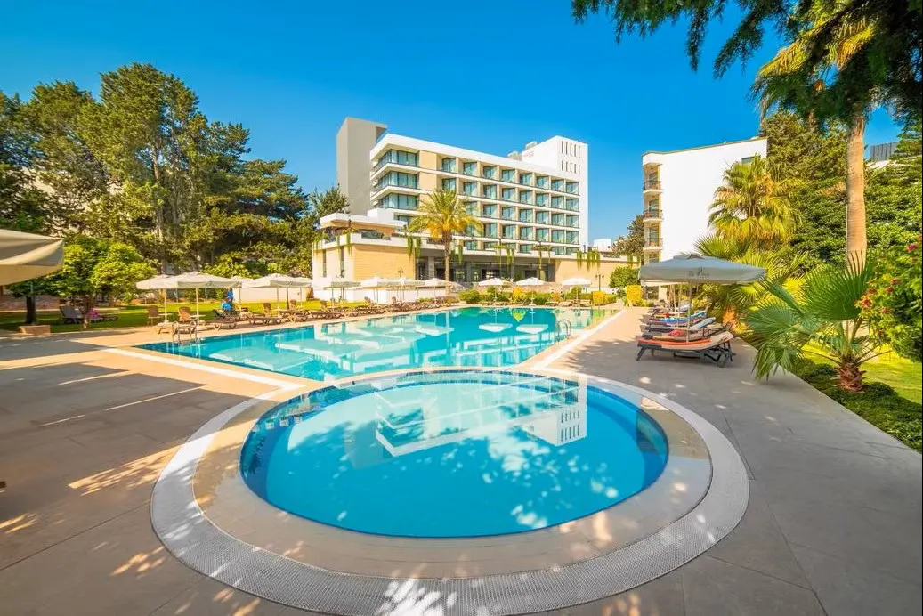 Luxury private taxi arriving at the beautiful gardens of Pia Bella Hotel in Kyrenia, North Cyprus